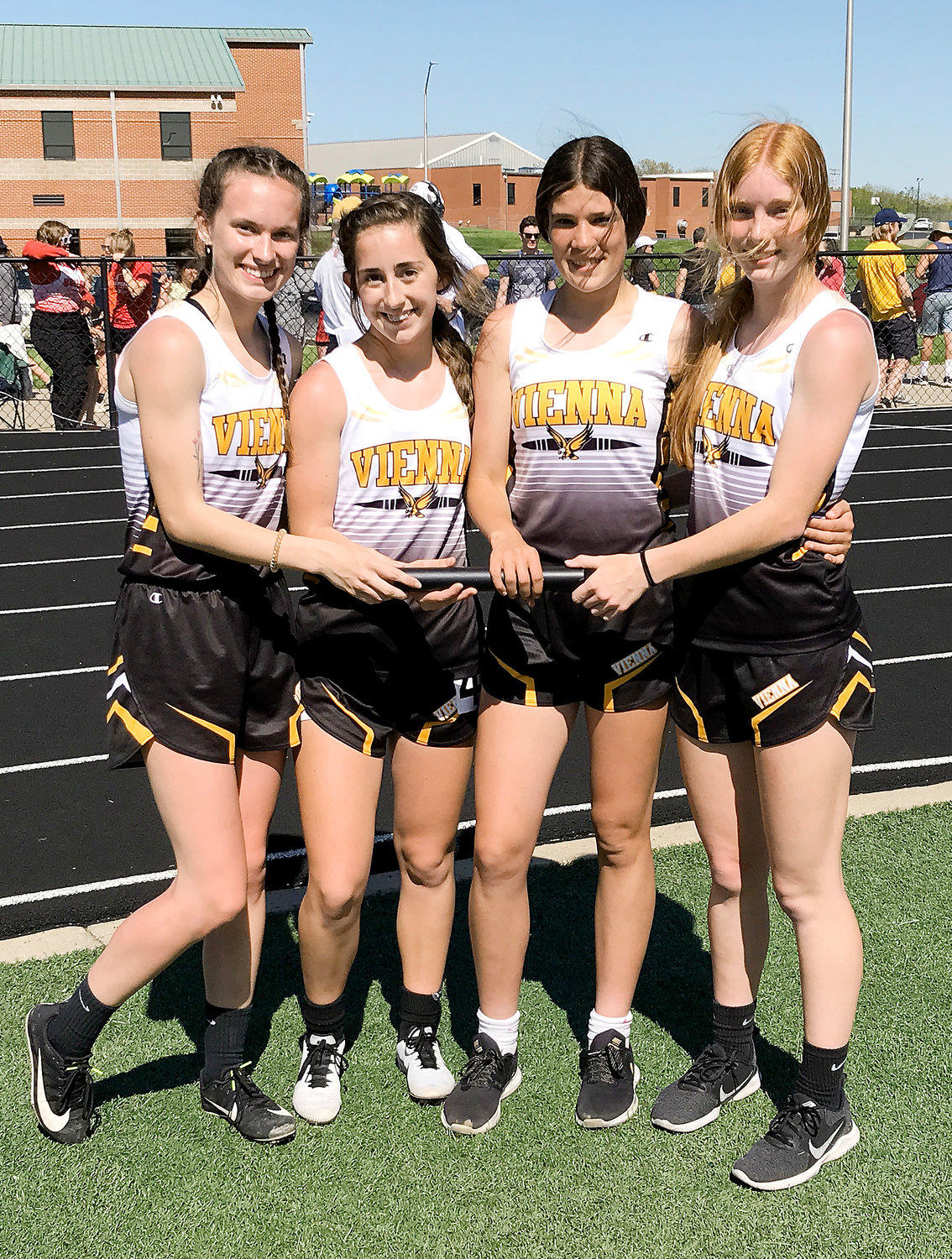 Vienna’s girls 4x400-meter relay team of (from left) Tori Schulte, Jaedyn Schell, Aubrey Reeves and Madison Weeks celebrate their district-championship winning time of 4:27.01 with a group photo following the conclusion of their race.
